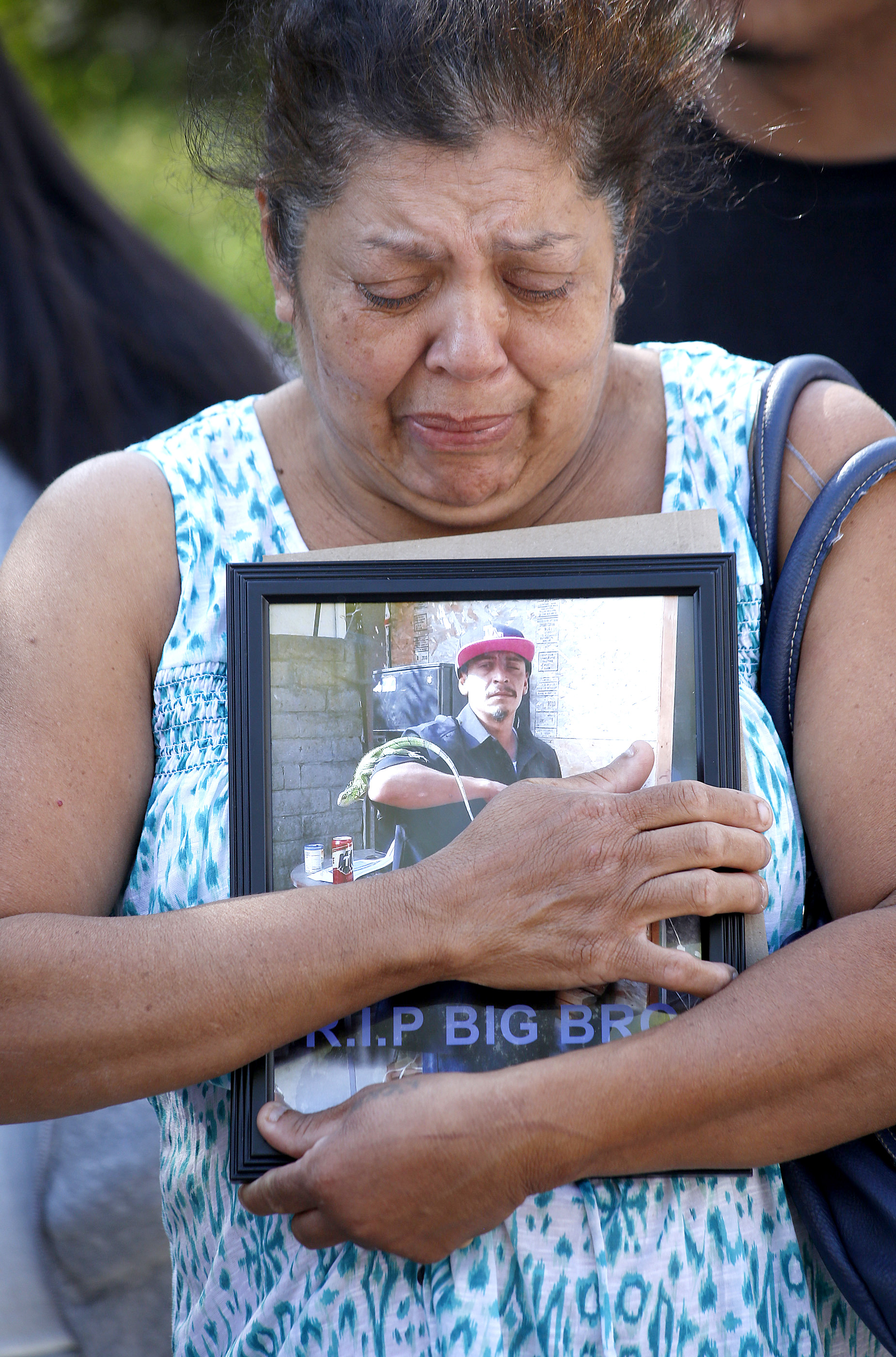 09/01/16/ LOS ANGELES/Mona Martinez, holding a photograph of her deceased son David Coborubio, and surrounded by her children and attorney Jaime Segall-Gutierrez, held a news conference, in front of the Kenneth Hahn Hall of Administration, shortly before filing a claim for damages against the Los Angeles County Sheriff's Department, contending Coborubio was ``brutally murdered'' earlier this year during a search of his family's home conducted by theÊFBIÊand sheriff's deputies. (Photo by Aurelia Ventura/ La Opinion)