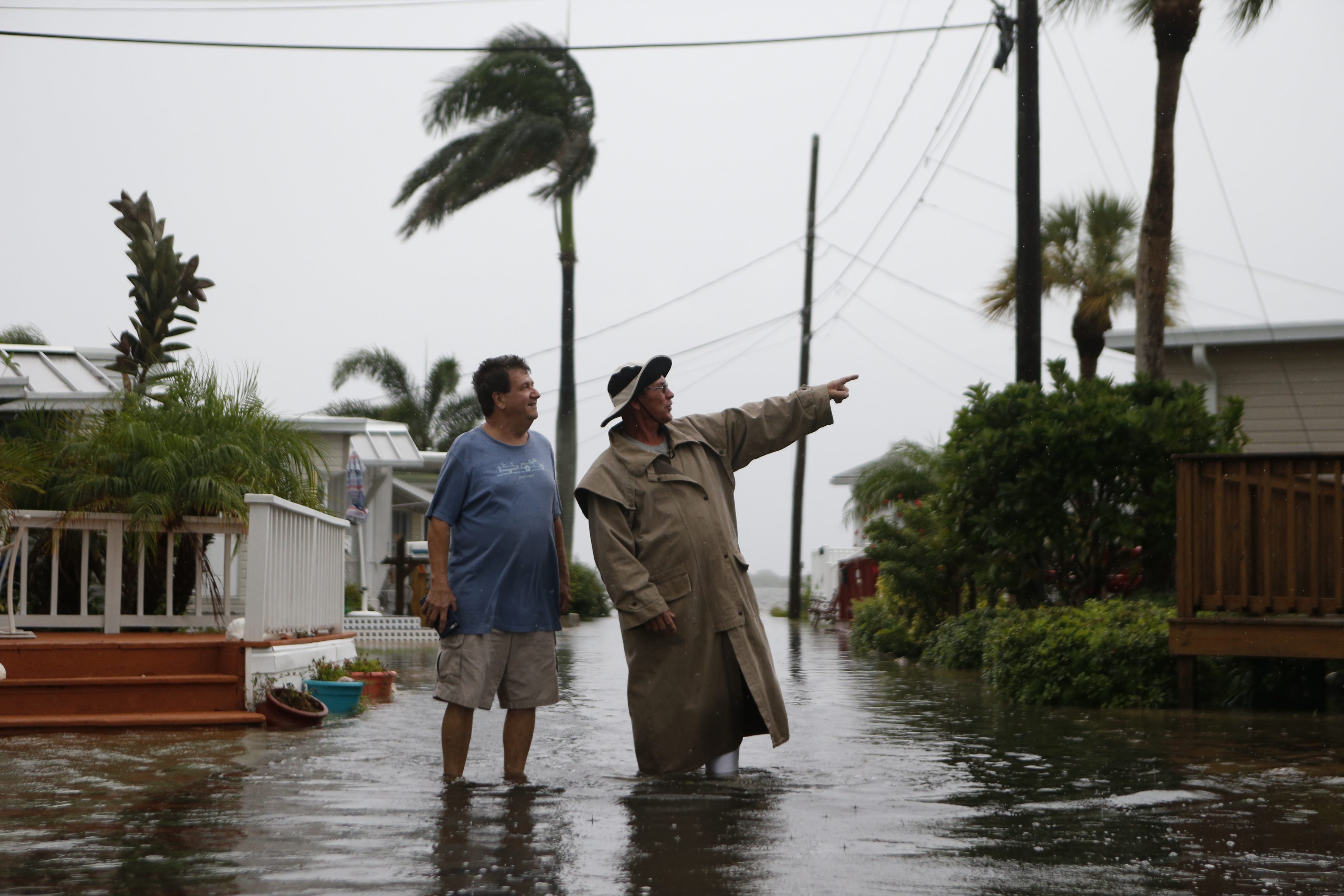 HOLMES BEACH, FL - SEPTEMBER 1: Residents of the Sandpiper Resort survey the rising water coming from the Gulf of Mexico into their neighborhood as winds and storm surge associated with Tropical Storm Hermine impact the area on September 1, 2016 at in Holmes Beach, Florida. Hurricane warnings have been issued for parts of Florida's Gulf Coast as Hermine is expected to make landfall as a Category 1 hurricane.