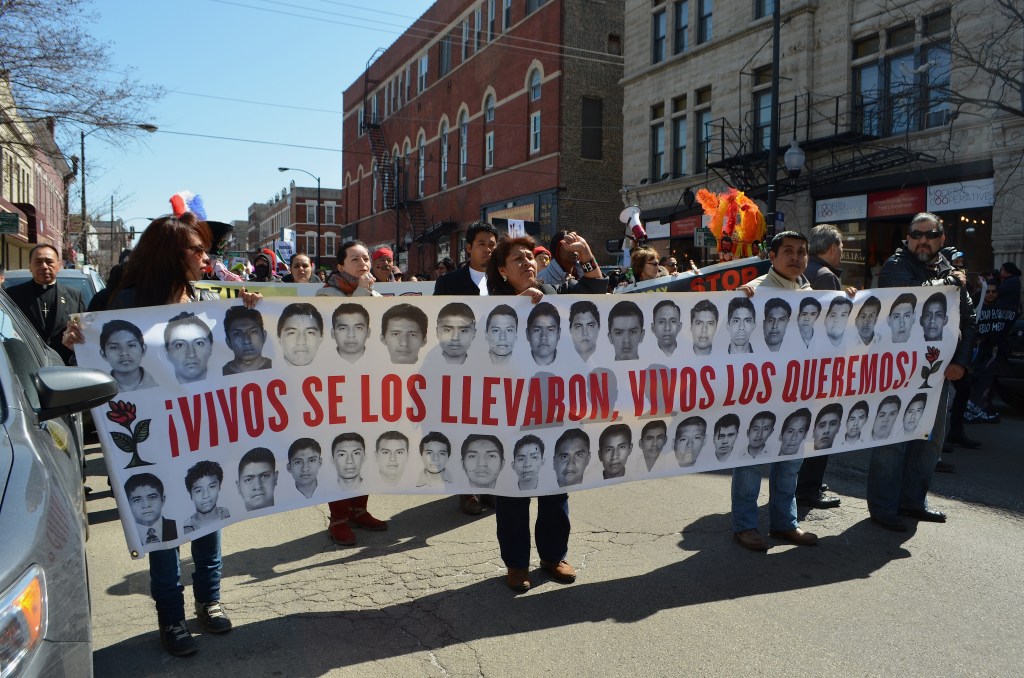 Familiares de estudiantes normalistas desaparecidos de Ayotzinapa, integrantes de la Caravana 43, durante una marcha por el vecindario de Pilsen en Chicago, en abril pasado. 