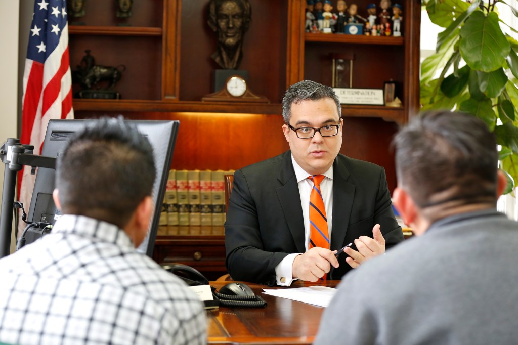 01/22/16 / LOS ANGELES/19 year-old Juan Lopez with his father Jose speak to their attorney Alex Galvez in Downtown Los Angeles. (Photo by Aurelia Ventura/La Opinion)