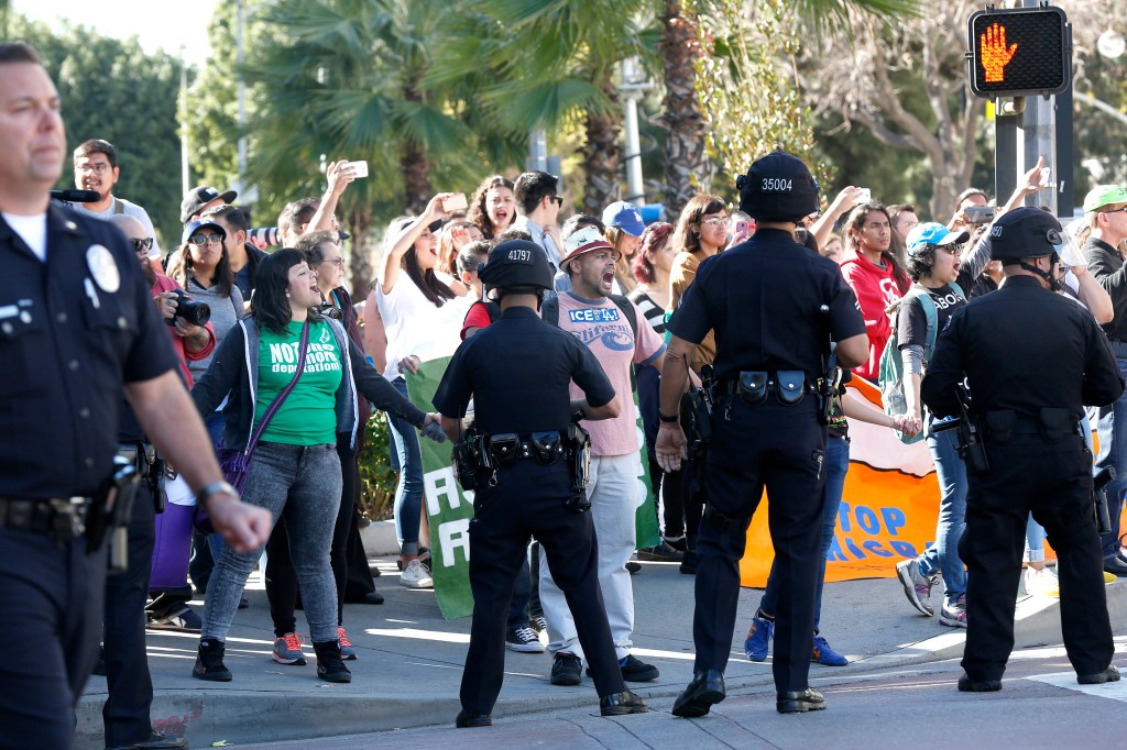 01/26/16 / LOS ANGELES/Immigrant-rights protesters are arrested after blocking, for several hours, an intersection outside the Immigration and Customs Enforcement offices in downtown Los Angeles. 7 demonstrators, demanding a stop to deportation of Central American immigrant families, had to be cut from a device, described as "sleeping dragon", that linked the protesters arm-in-arm on the ground. (Photo by Aurelia Ventura/La Opinion)