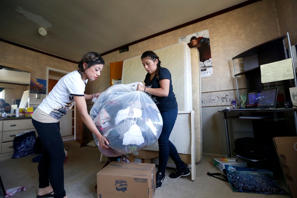 03/24/16 /RIALTO / Merari Caamal (R) with sister Elizabeth, a Rialto family facing eviction, pack their belongings at their Rialto home. The Caamal family speak about their efforts to keep their home and their refusal to leave their upcoming scheduled eviction day (Friday 3/25). They and their supporters call on property investment company Wedgewood Inc to sell the familyÕs home back to them. (Photo Aurelia Ventura/La Opinion)