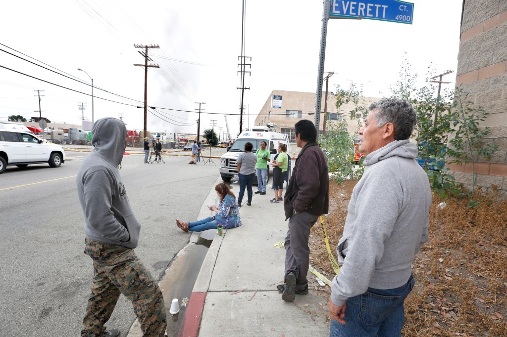 06/14/16/ LOS ANGELES/Gemini Plastic Enterprises employees Jose Pineda (R) and Frank Sitani (L) watch as firefighters fight a blaze in the 3700 block of Fruitland Avenue in Maywood. The fire reported at 2:30 a.m. in a recycling center next to Gemini Plastic Enterprises, according to the Los Angeles County Fire Department. The fire sparked a series of strong explosions, knocking out power and forcing the evacuation of residents and nearby workers while sending a thick plume of potentially toxic smoke over the region. (Photo Aurelia Ventura/ La Opinion)