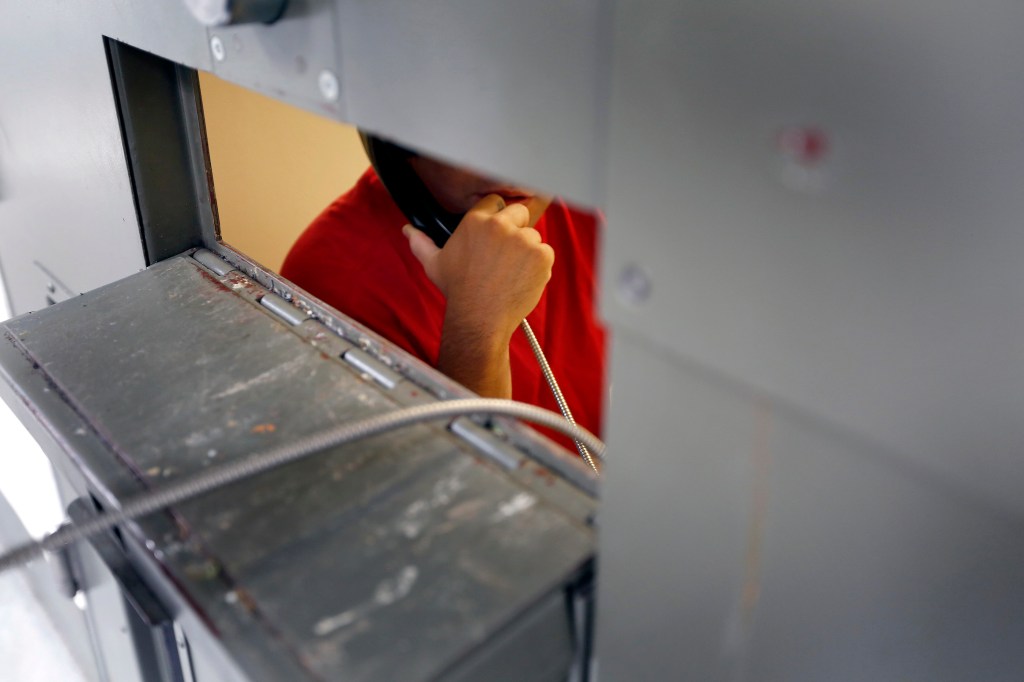 06/21/16/ ADELANTO/ An immigrant detainee makes a call from his 'segregation cell' at the Adelanto Detention Center. The facility, the largest and newest Immigration and Customs Enforcement (ICE), detention center in California, houses males and females an average of 1,700 immigrants in custody pending a decision in their immigration cases or awaiting deportation. (Photo Aurelia Ventura/ La Opinion)