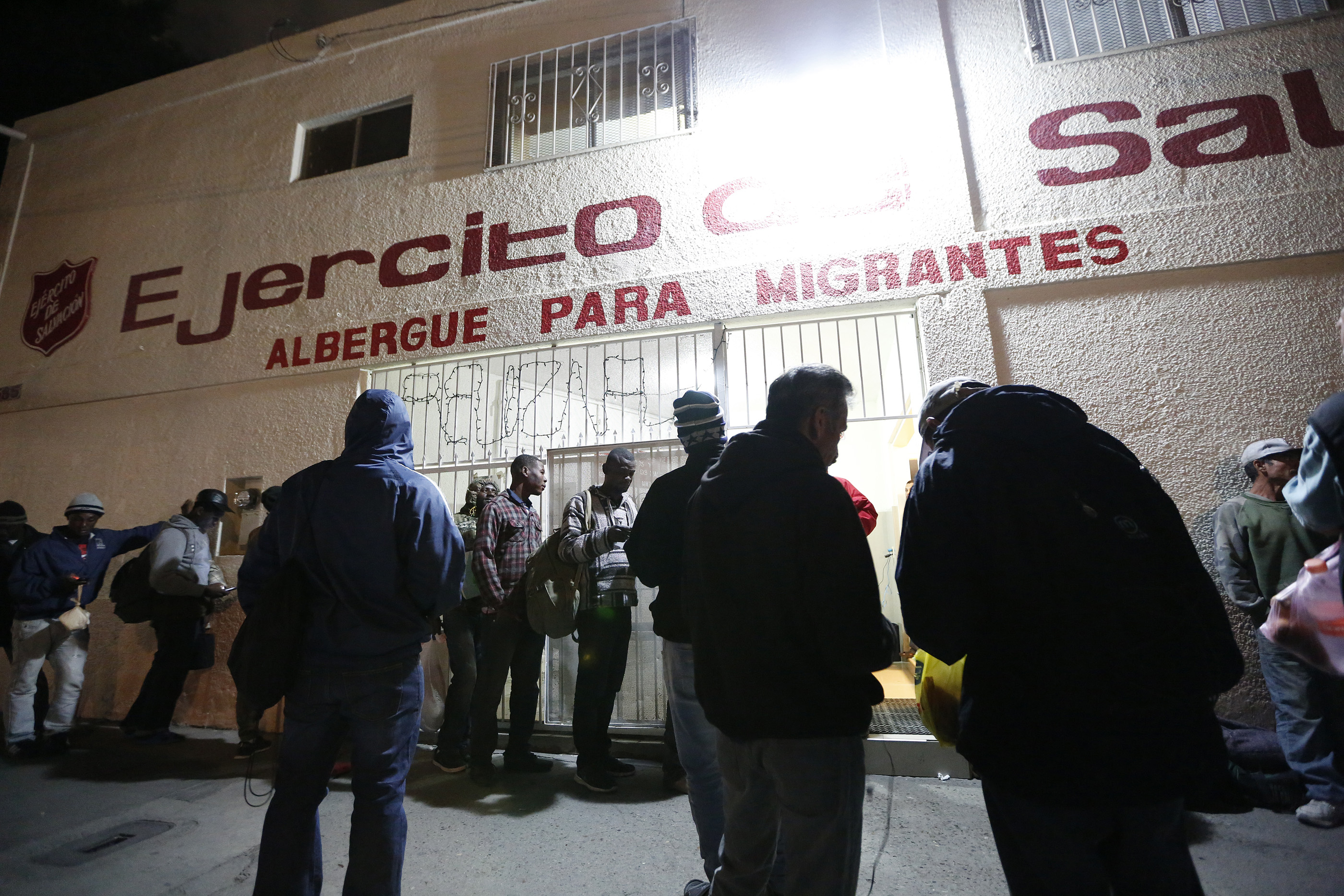 12/08/16/ TIJUANA/A large group of Haitian refugees wait to enter the Salvation Army shelter in Tijuana. An unprecedented arrival of Haitians and others seeking entry into the United States in recent weeks has sent Tijuanas migrant shelters scrambling to find beds, blankets, food and other necessities to serve this increase of people awaiting processing by U.S. authorities. (Photo Aurelia Ventura/ La Opinion)